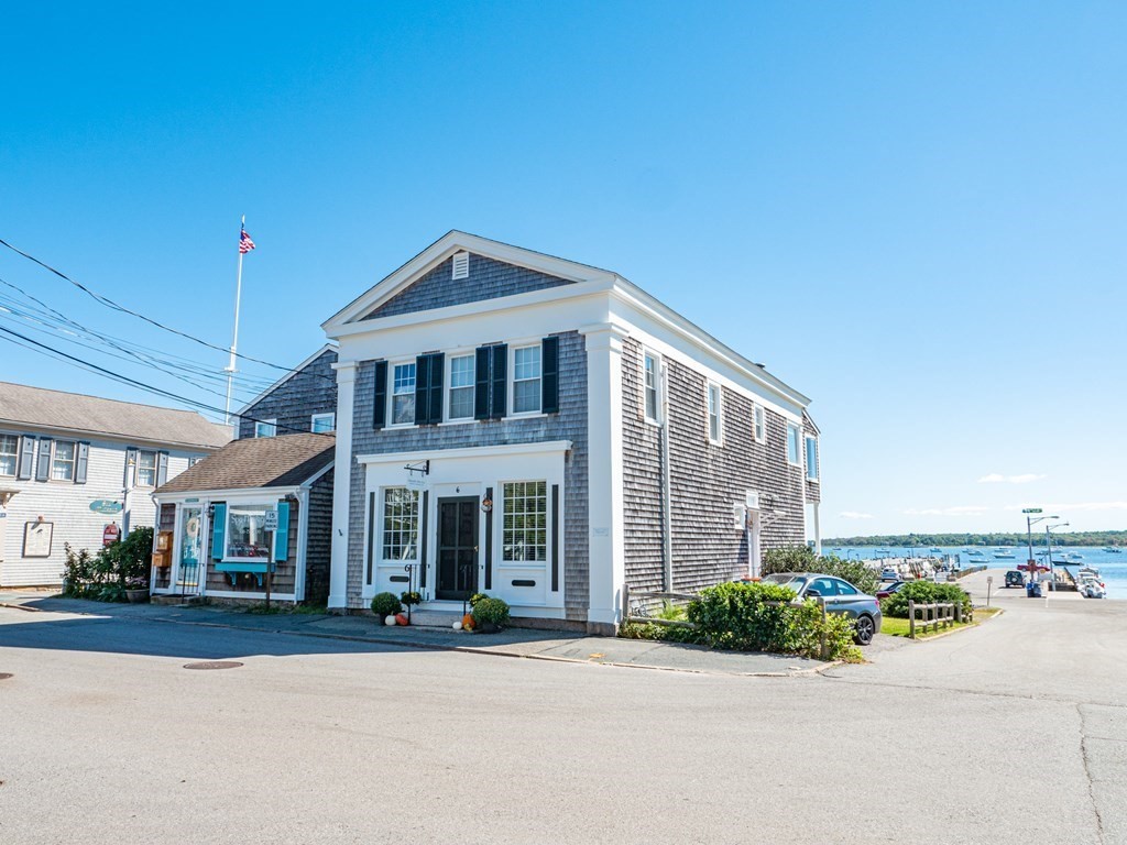 This very unique circa 1840's Colonial building with an iconic storefront in the seaside village of Mattapoisett is available for purchase!  Enjoy the glorious views of the Mattapoisett Harbor, Buzzards Bay and the active yachting scene while sitting in the comfort of your own home. Currently, there is rental office space on the ground floor and a lovely sunny two bedroom residence on the second floor. Entertain guests as they are mesmerized by all the surrounding views and activities. This location is footsteps to  sandy beaches, marinas, village shops and restaurants. The rental income is a strong incentive to invest in this property, zoned residential. If desired, one could convert the property to a single family home. The building underwent a major renovation in 2009 down to studs with new electric, plumbing, HVAC, kitchen, baths and walls. The 5 car parking spaces adds additional convenience for visitors. This versatile waterfront property in historic Mattapoisett village awaits!