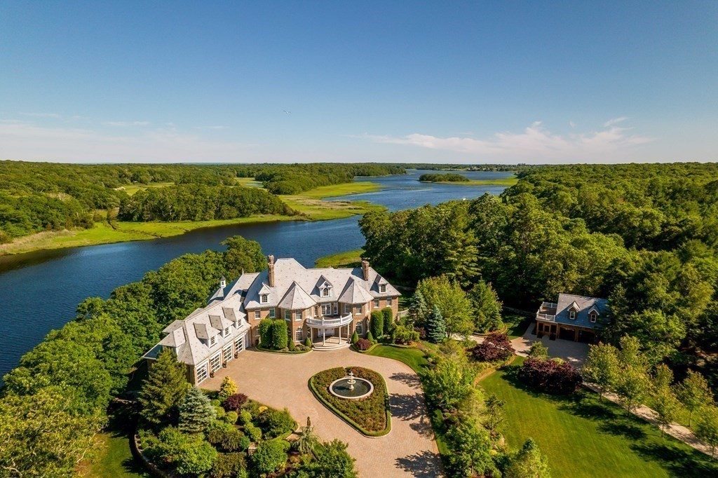 Enter the gates of this extraordinary estate and feel as though you are in the European countryside. Majestically situated overlooking the Slocum River w/ spectacular water-views. The estate sits on almost 10 acres of meticulously manicured grounds professionally designed & landscaped w/ extensive custom masonry work. The main house is comprised of 15+ rooms & is flawlessly & luxuriously appointed. It features high-coffered ceilings, walls of windows, exquisite millwork & rich architectural detailing. The lower level serves as an entertainment mecca w/ wine cellar, custom bar & game room. The three story layout offers a pleasing blend of formal and informal spaces to accommodate any entertaining need. The heated 56x30 barn offers a Tuscany flair with wood burning pizza oven. The property includes a vineyard, private floating dock & a regulation sized basketball court. Create endless memories for generations to come from the seclusions & solitude of this quintessential coastal retreat.
