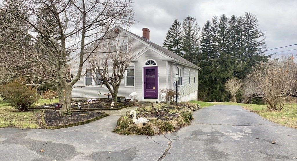 Sitting on over an acre of land this Cape Cod gable style home features 3 bedrooms, 1 full bath, spacious living room with a fireplace and dining room. Hardwood floors run throughout this home.  Endless possibilities upstairs in the partially finished full walk up attic space.