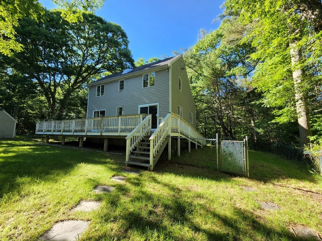 This 5 room, 2 bedroom, 1.5 bath home, sits on 1.11 acres with a 3.1 acre parcel behind it with a total land amount of 4.1 acres, in desirable South Dartmouth.  You have seclusion yet accessibility to area amenities such as, beaches, rivers, conservation areas, shopping, medical facilities, and Houses of Worship.  The property also has a two car garage with a floor above containing a skylight and a 680 square foot deck off the kitchen, as well as a handicap ramp.  There is a possibility of creating a guest cottage out of the two car garage or building a separate one.  Buyer Agent + Buyer must do due diligence with the Town for compliance.  USA Realty Group, Inc is only stating that this is a possibility.  The engineer is designing a new 3 bedroom septic system.  There is a woodstove in the living room and the home also has a full unfinished basement.