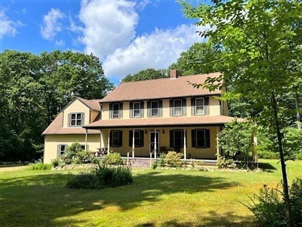 SPACIOUS COLONIAL ON 6 ACRES ABUTTING STATE FOREST is a PEACEFUL SANCTUARY offering WONDERFUL PRIVACY!  Built in 2001, w/ a sizable addition (2003), the property has over 3,000 sq. ft. of living space & many living options. 1st flr comprises a lg OP Living/Dining Rm. w/ a high-efficiency wood stove set in a handsome fieldstone FP. The upgraded Kitchen is large & open w/ Dining Area & Breakfast Peninsula. An Office & 1/2 Bath complete the 1st flr.  Gleaming hardwood floors w/ custom tile inserts throughout the living areas. On the 2nd flr, there are 3 Bedrooms, including the Main Suite, & a Family Bath. Above an oversized 2-car garage is a beautiful Bonus Rm w/ a 2nd wood-burning FP currently used as a Study. This room could be a Study, Family Rm, Playroom, or Exercise Rm. Sliders access a lg. upper deck connected to a lower deck accessed off the Kitchen. AC. Extensive UG rainwater drainage system. Surrounded by woods, stream, fieldstone walls & trails. Rt. 31 is 6 mins. - Paxton is 10.